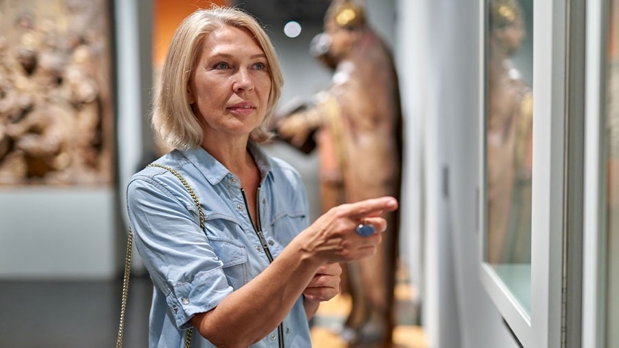 A woman visitor in the historical museum looking at pictures